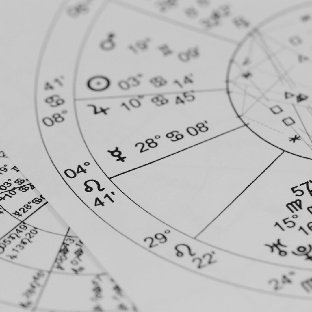 close up of printed natal chart with planets in houses
