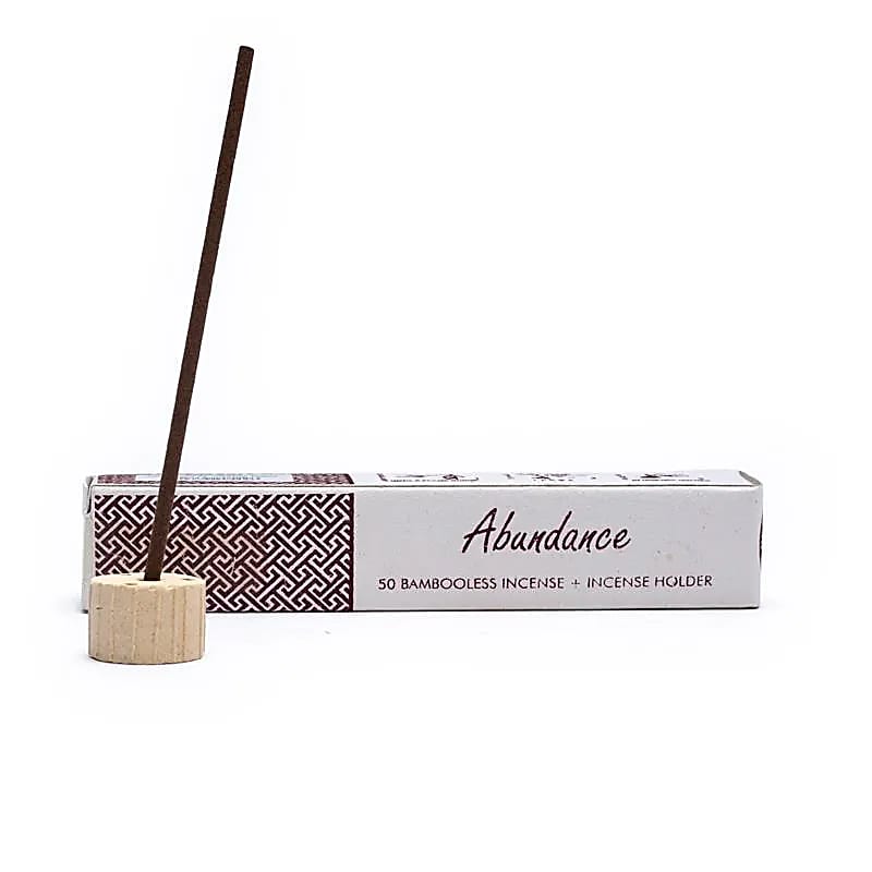 white paper box with abundance incense showing a stick in provided burner on white background