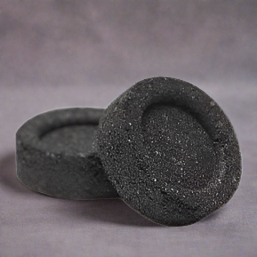 close up of two charcoal disc for incense burning