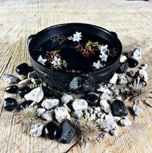 witchcraft offering or scrying bowl filled with water and jasmine flowers