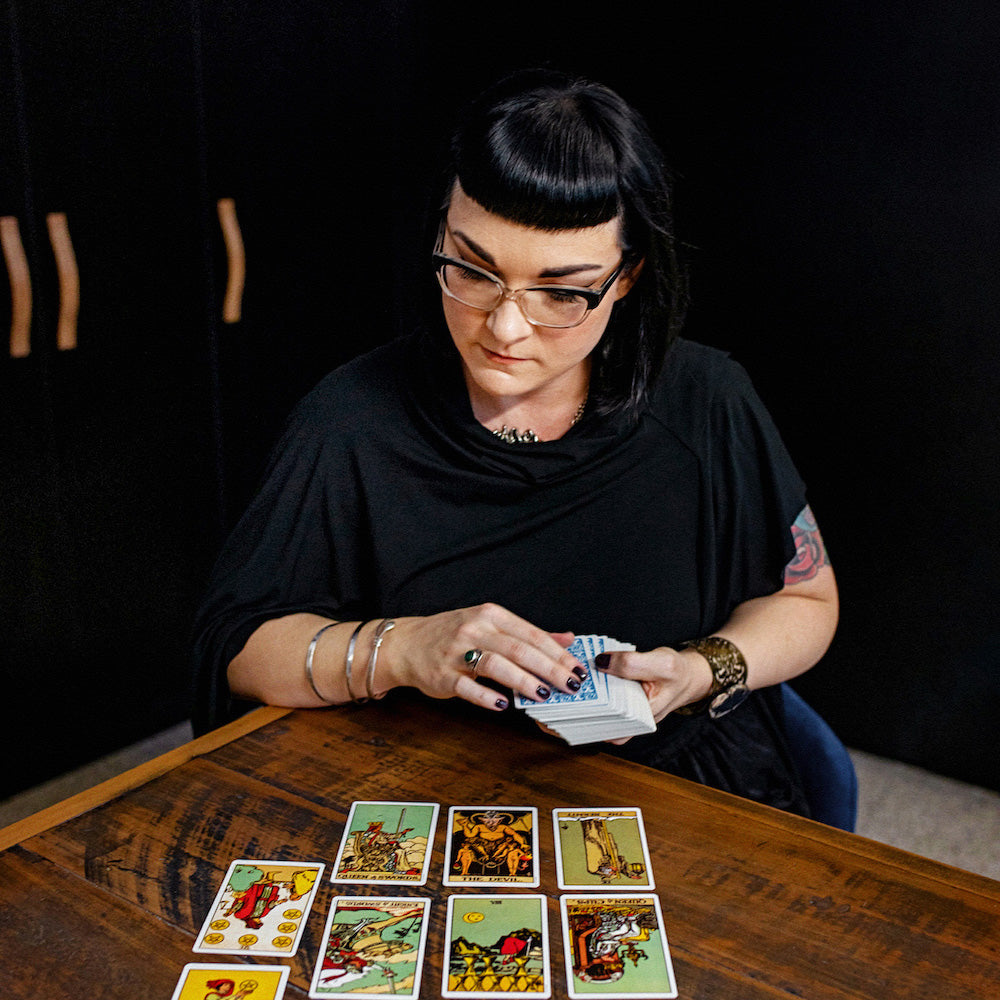 aliya hutchison of soap cult australia reading tarot cards on wooden table