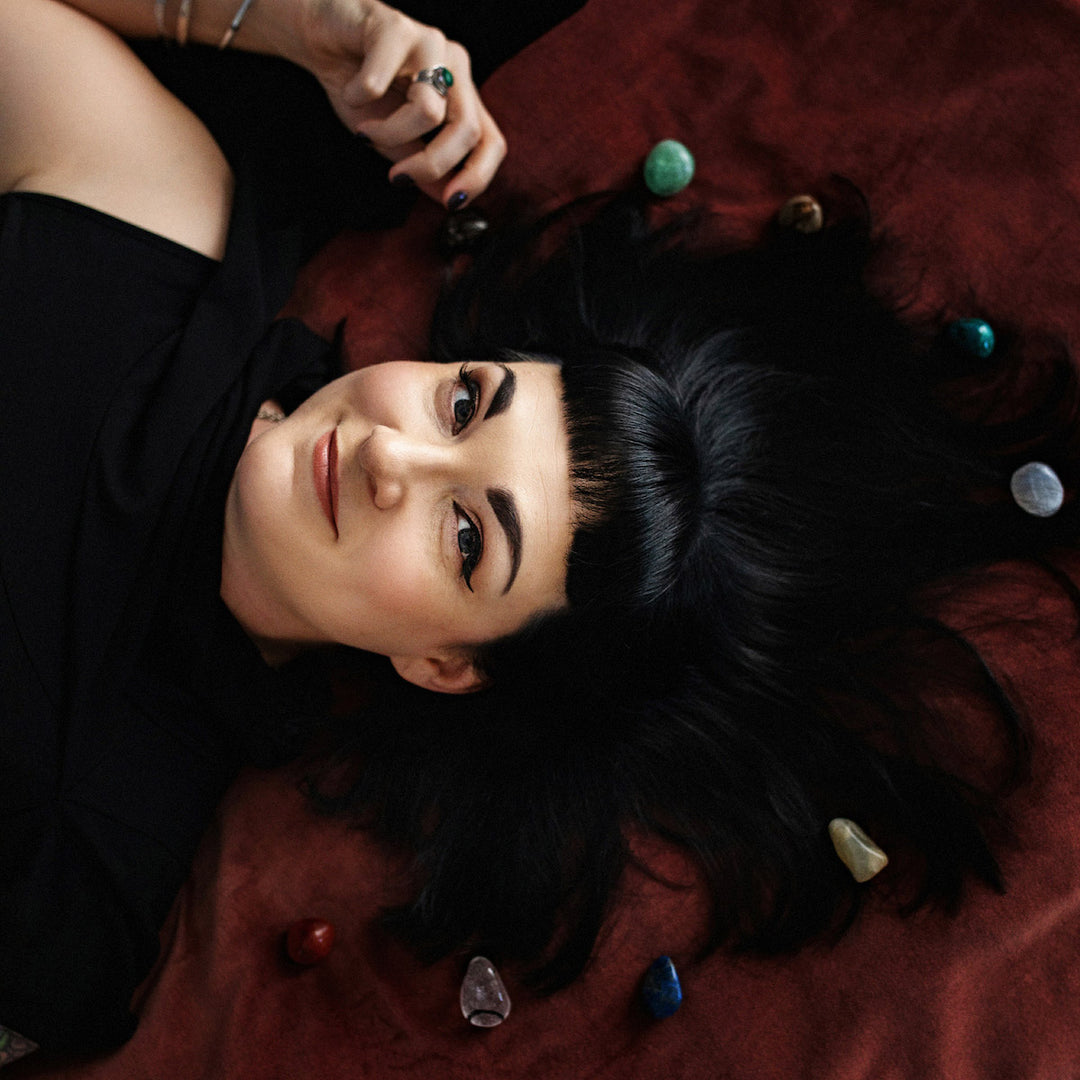 aliya hutchison of soap cult australia laying on velvel surrounded with crystals