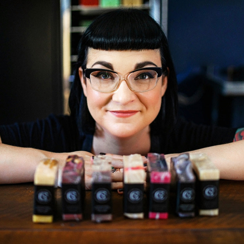 soap cult australia founder aliya hutchison with soap lined up in front of her