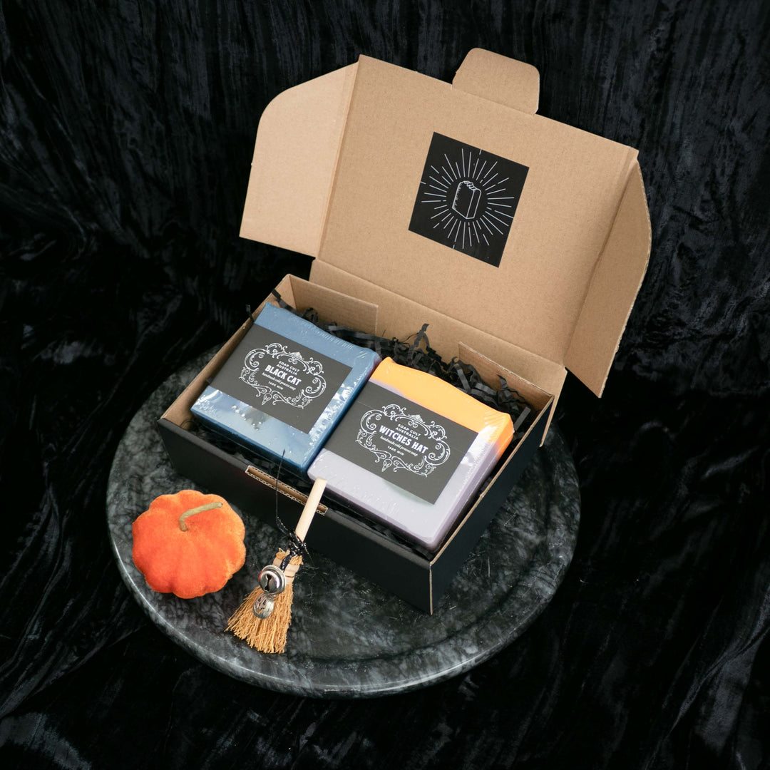 spooky christmas gift box with black cat and witches hat soap on black shred